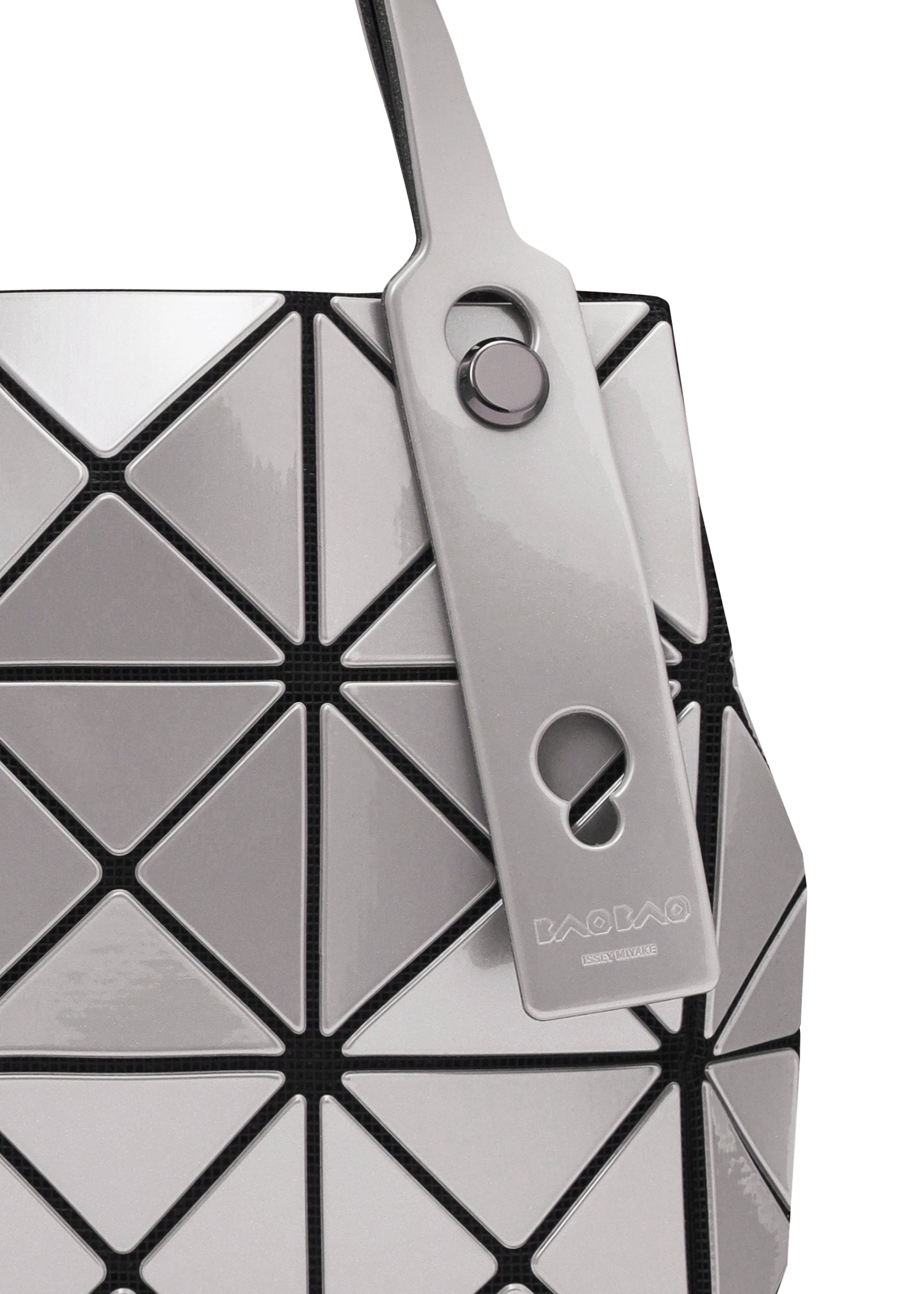 Zoomed view Close-up of the geometric, silver and black BAO BAO ISSEY MIYAKE CARAT handbag with metallic triangular panels, a matching tag on the handle, and an inner pocket for functionality.
