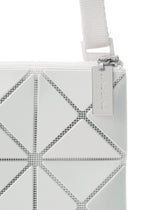 Close-up of the LUCENT METALLIC shoulder bag by BAO BAO ISSEY MIYAKE, featuring white enamel triangular panels, a visible strap and zipper, and a metallic tag on the pull.