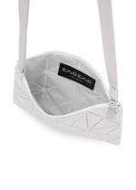The LUCENT METALLIC by BAO BAO ISSEY MIYAKE is a white geometric crossbody bag with a zippered top, metallic finish, gray patterned lining, and an interior logo label.