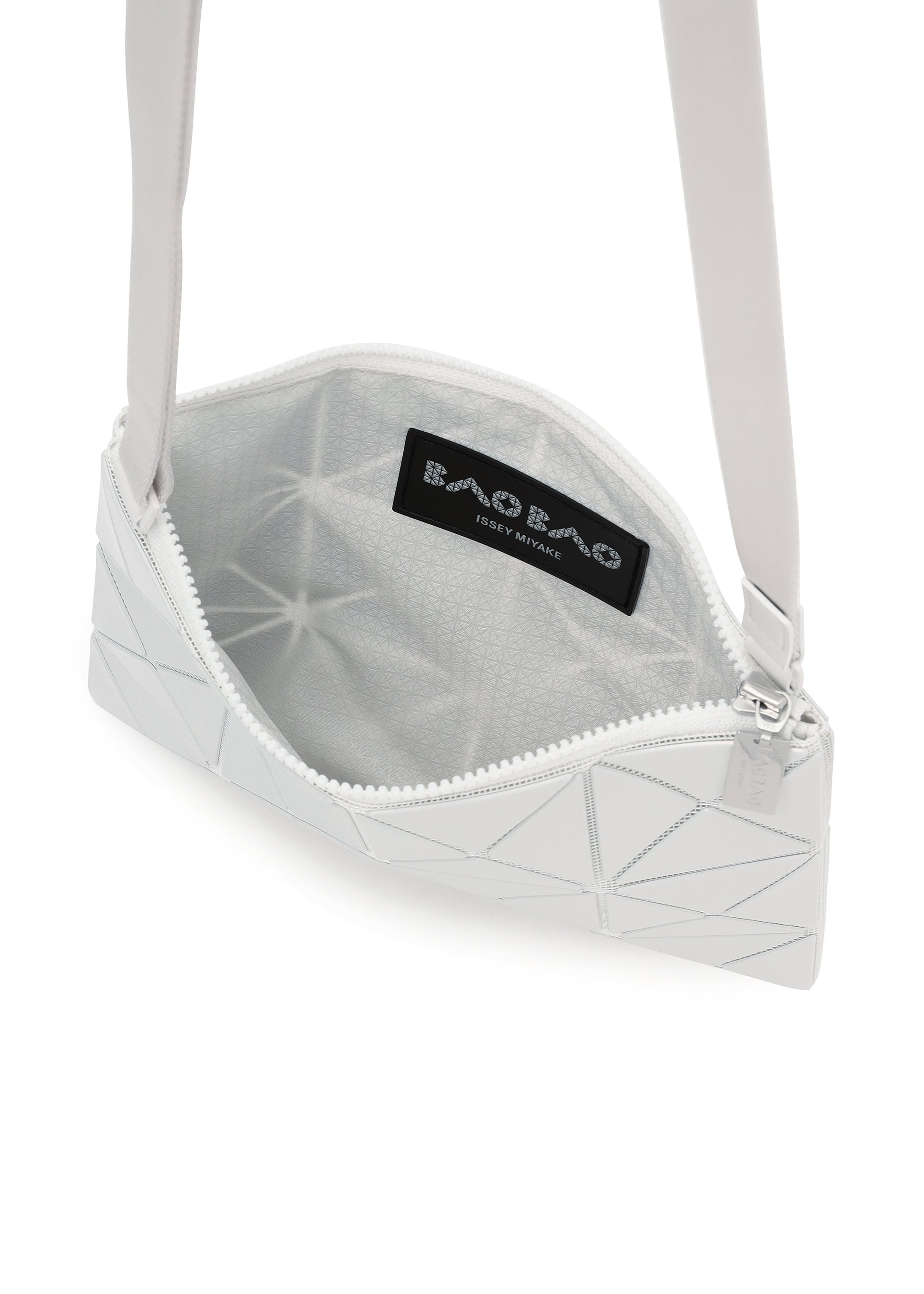 Zoomed view The LUCENT METALLIC by BAO BAO ISSEY MIYAKE is a white geometric crossbody bag with a zippered top, metallic finish, gray patterned lining, and an interior logo label.