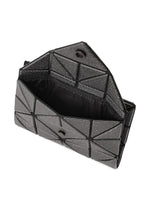 The BAO BAO ISSEY MIYAKE CARD WALLET is a black geometric-patterned mini wallet with an open flap and snap closure, offering a roomy main compartment with black lining—ideal for a cash-less lifestyle.