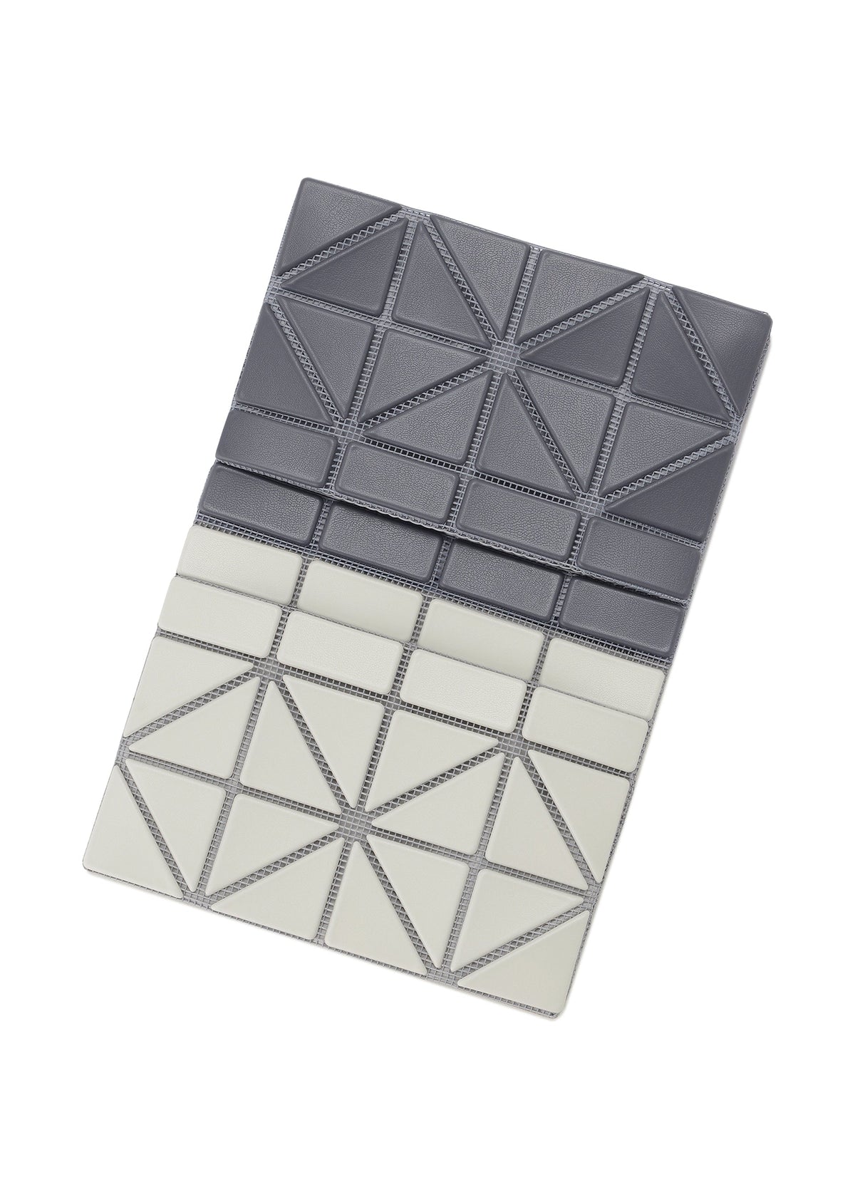 The CARD CASE W COLOR by BAO BAO ISSEY MIYAKE is a rectangular bifold card case featuring geometric triangular patterns in dark gray and light gray, creating a sleek two-tone look, displayed on a white background. view 2 of 11