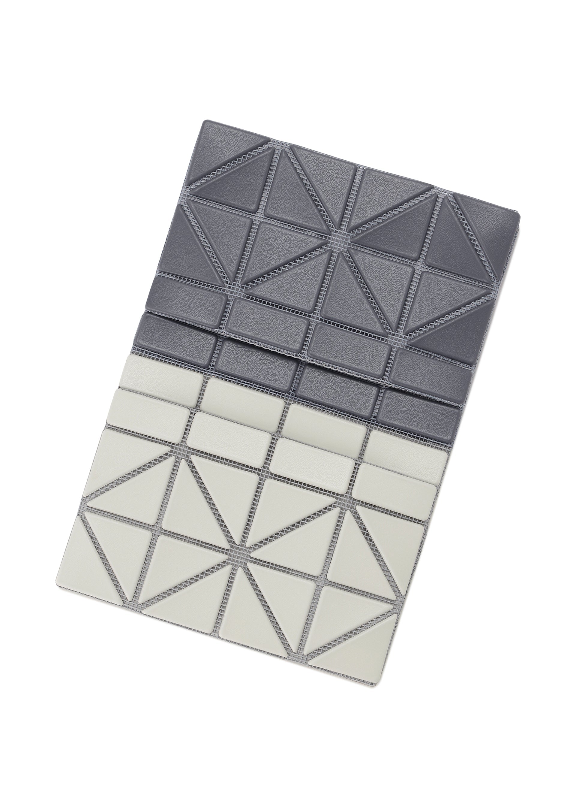 Zoomed view The CARD CASE W COLOR by BAO BAO ISSEY MIYAKE is a rectangular bifold card case featuring geometric triangular patterns in dark gray and light gray, creating a sleek two-tone look, displayed on a white background.
