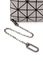 Close-up of the FLIPPER bag by BAO BAO ISSEY MIYAKE, featuring a geometric pattern, silver chain strap, and metal clasp—ideal for carrying essentials like a commuter pass case or business card holder on a white surface.