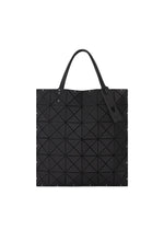 The BAO BAO ISSEY MIYAKE MAP tote bag features black geometric triangles, dual handles, and a decorative tag on one handle.