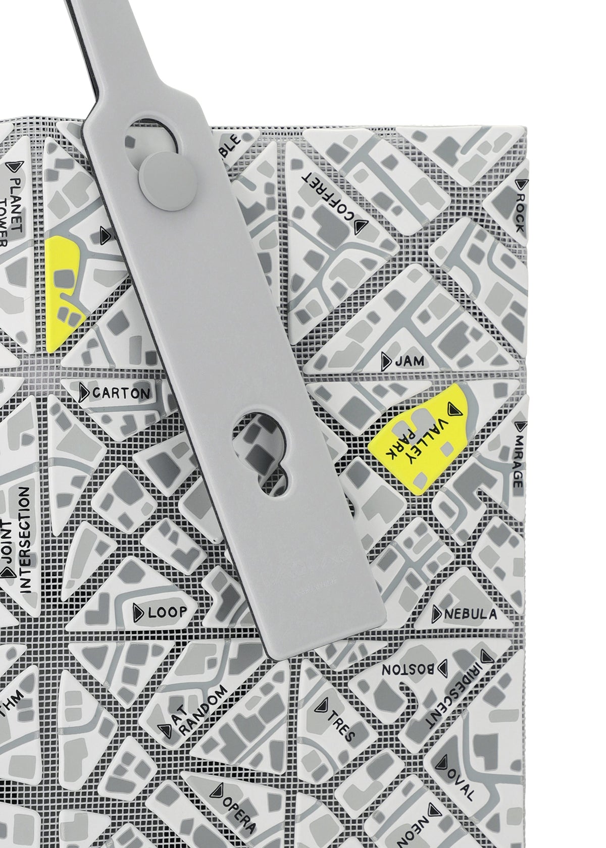A gray binder clip fastens a BAO BAO ISSEY MIYAKE MAP folder featuring a geometric street map design with names like VAULT, JAM, and NEBULA highlighted in yellow. view 6 of 10