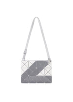 The SIGN shoulder bag by BAO BAO ISSEY MIYAKE features a white and gray geometric triangular pattern, a rectangular shape, a long adjustable strap, and a subtle road sign motif.