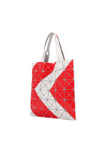 The SIGN tote by BAO BAO ISSEY MIYAKE features red and white triangular panels in a bold zigzag pattern with silver accents and two gray handles. It's spacious enough for A4 documents or a 13-inch laptop.