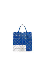 The SIGN tote by BAO BAO ISSEY MIYAKE features a blue and white grid with triangular segments, blue handles, and a contrasting white corner. Designed to fit a 13-inch laptop or A4 documents, it's both geometric and practical.