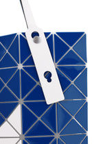 Close-up of the SIGN tote bag by BAO BAO ISSEY MIYAKE in blue and white geometric segments, with a white strap featuring two circular cutouts; perfectly sized for A4 documents or a 13-inch laptop.