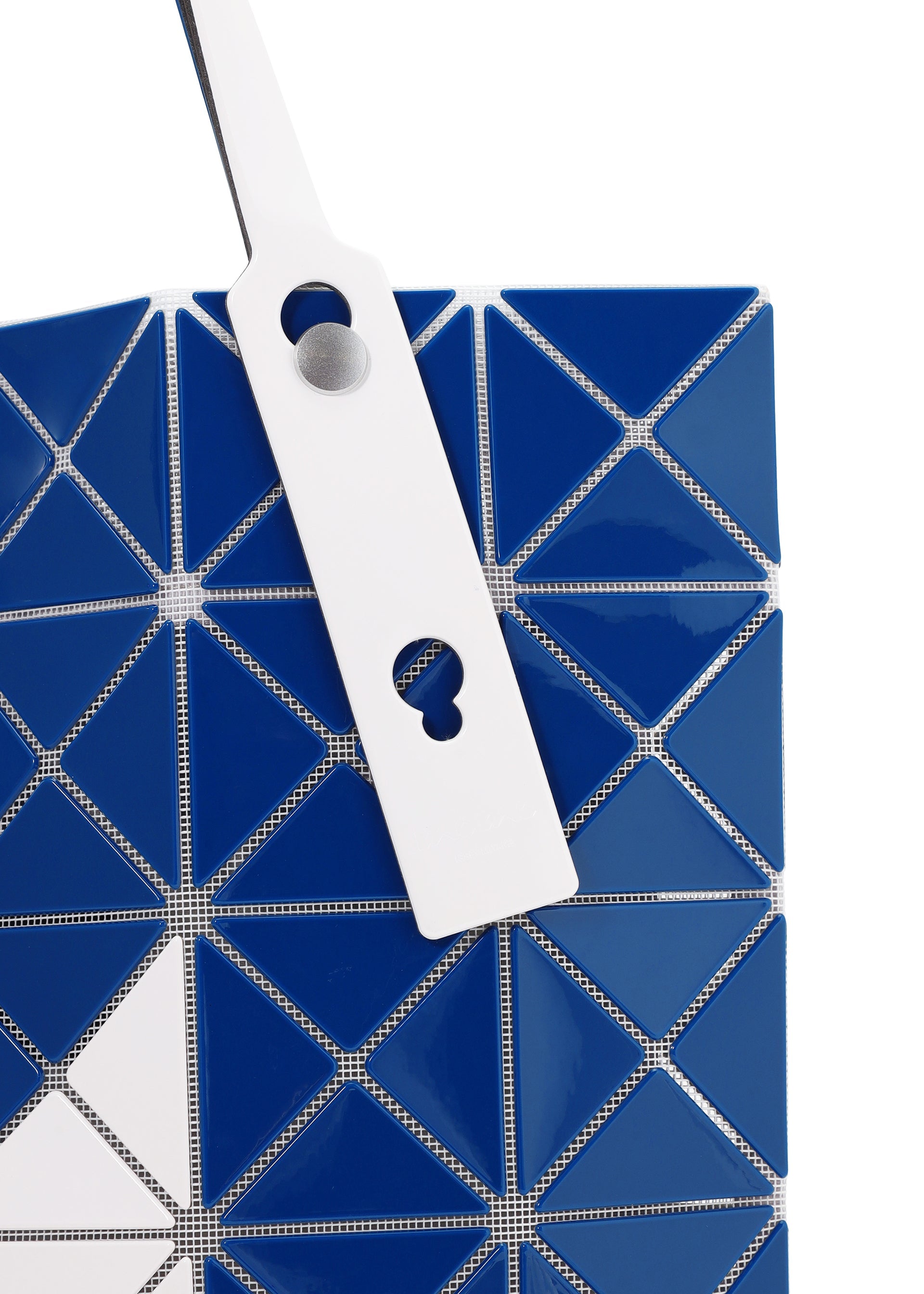 Zoomed view Close-up of the SIGN tote bag by BAO BAO ISSEY MIYAKE in blue and white geometric segments, with a white strap featuring two circular cutouts; perfectly sized for A4 documents or a 13-inch laptop.