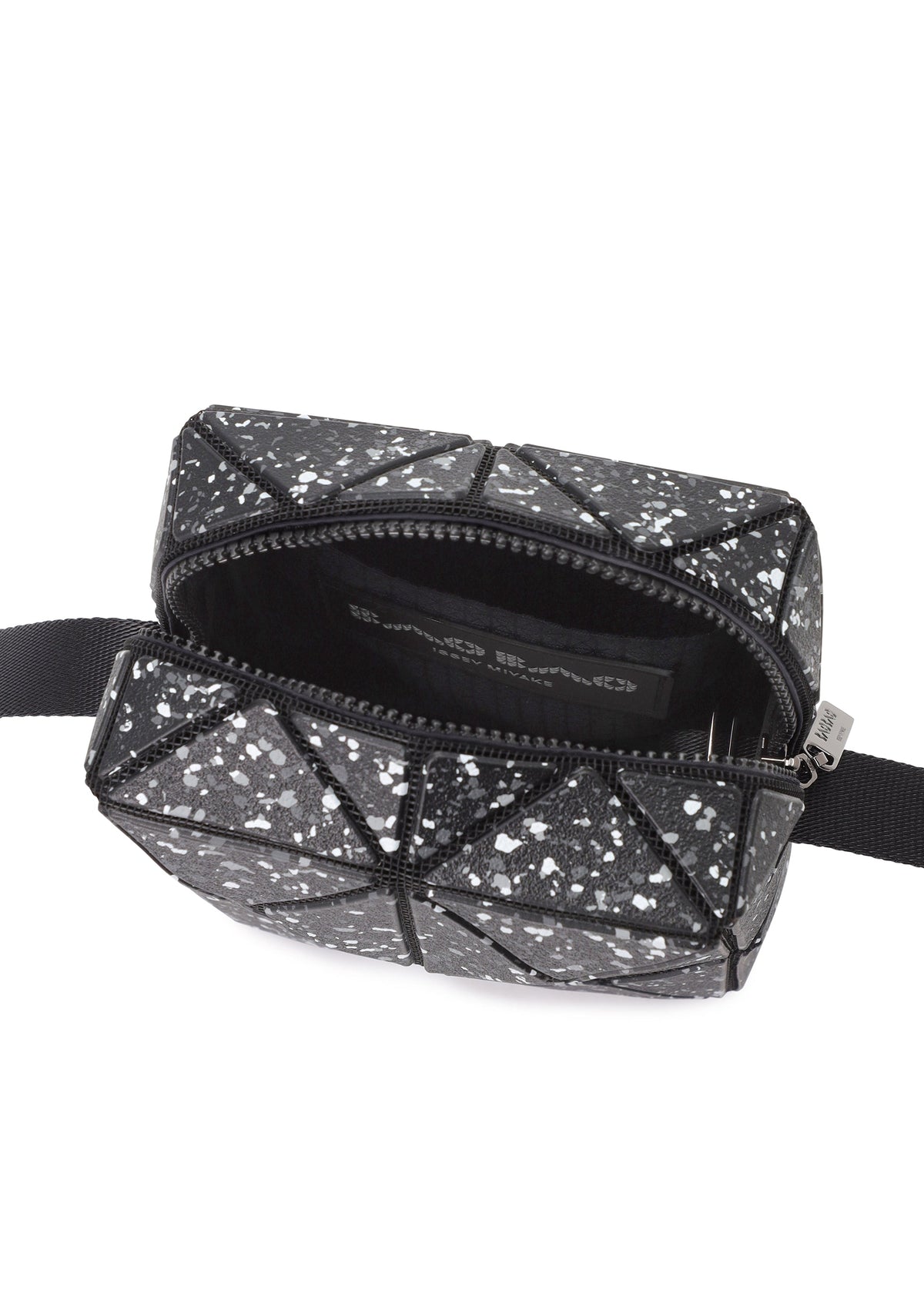 The CITY by BAO BAO ISSEY MIYAKE is a small black geometric shoulder bag with white speckles, a leather-like matte finish, open zipper, black adjustable side straps, and a simple black-lined interior. view 7 of 9