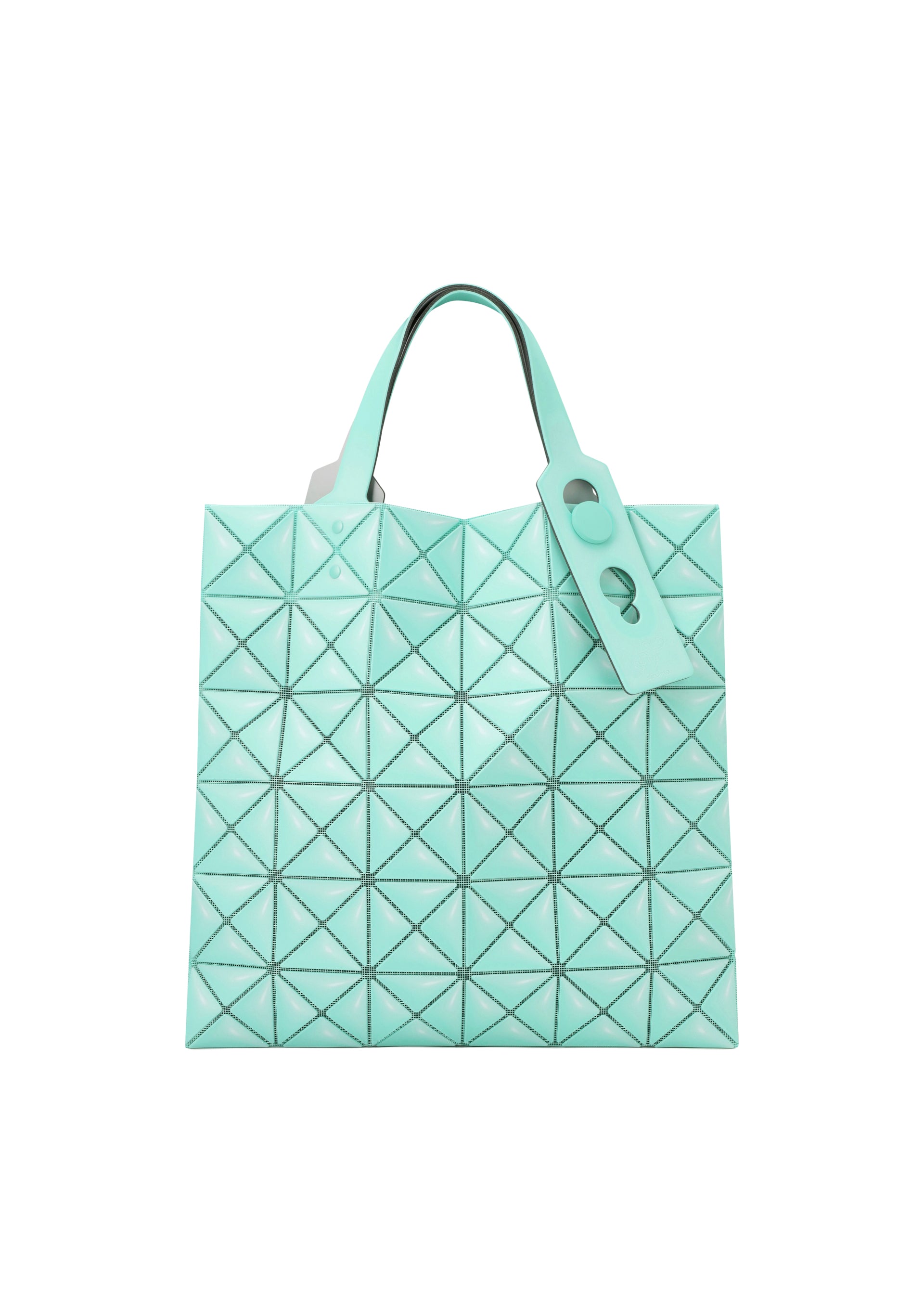 Zoomed view The MINIATURE tote by BAO BAO ISSEY MIYAKE is mint green with geometric triangular patterns, a leather-like finish, two handles with oversized metal hardware, and a matching tag on one handle.