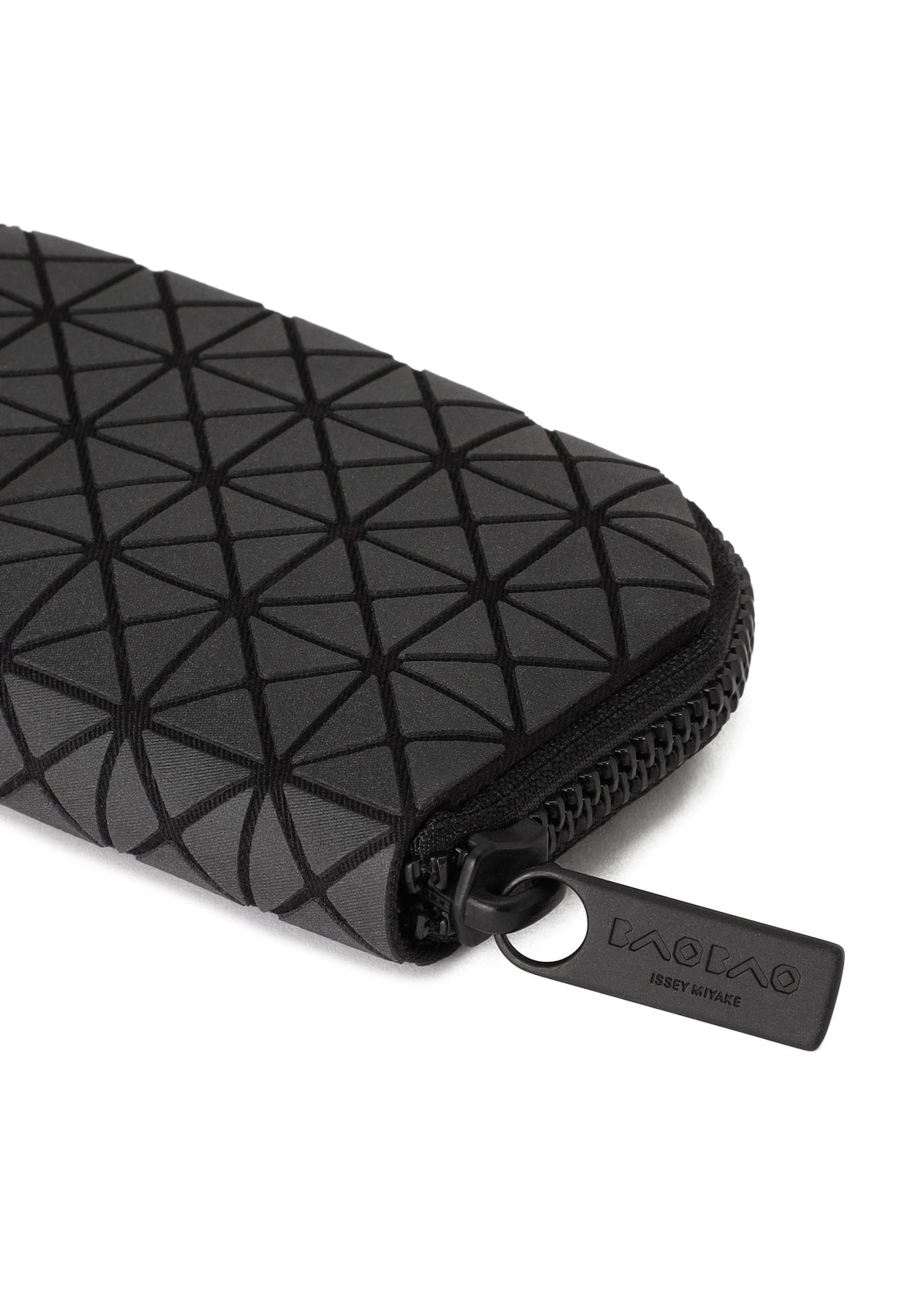 A close-up of the FRAGMENT black zippered pouch by BAO BAO ISSEY MIYAKE, featuring a geometric triangle pattern and a branded zipper pull, perfect as a stylish credit card holder. view 2 of 3