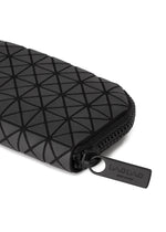 A close-up of the FRAGMENT black zippered pouch by BAO BAO ISSEY MIYAKE, featuring a geometric triangle pattern and a branded zipper pull, perfect as a stylish credit card holder.