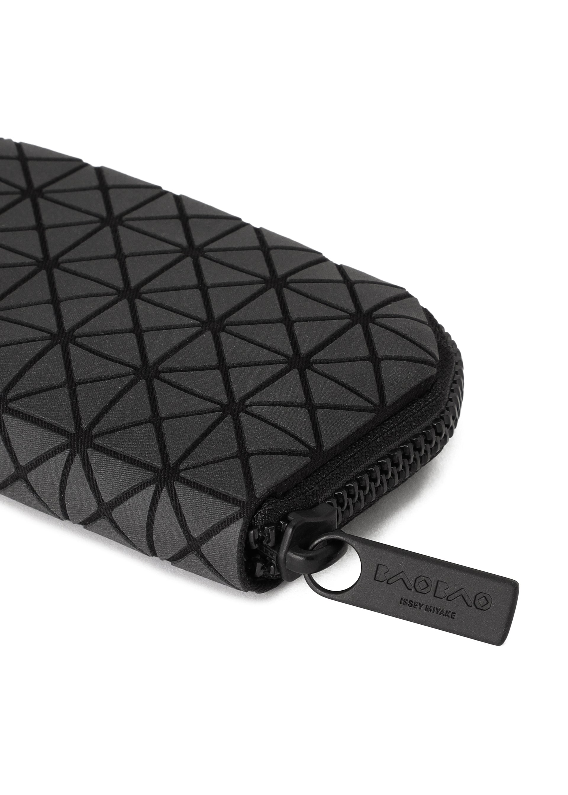 Zoomed view A close-up of the FRAGMENT black zippered pouch by BAO BAO ISSEY MIYAKE, featuring a geometric triangle pattern and a branded zipper pull, perfect as a stylish credit card holder.