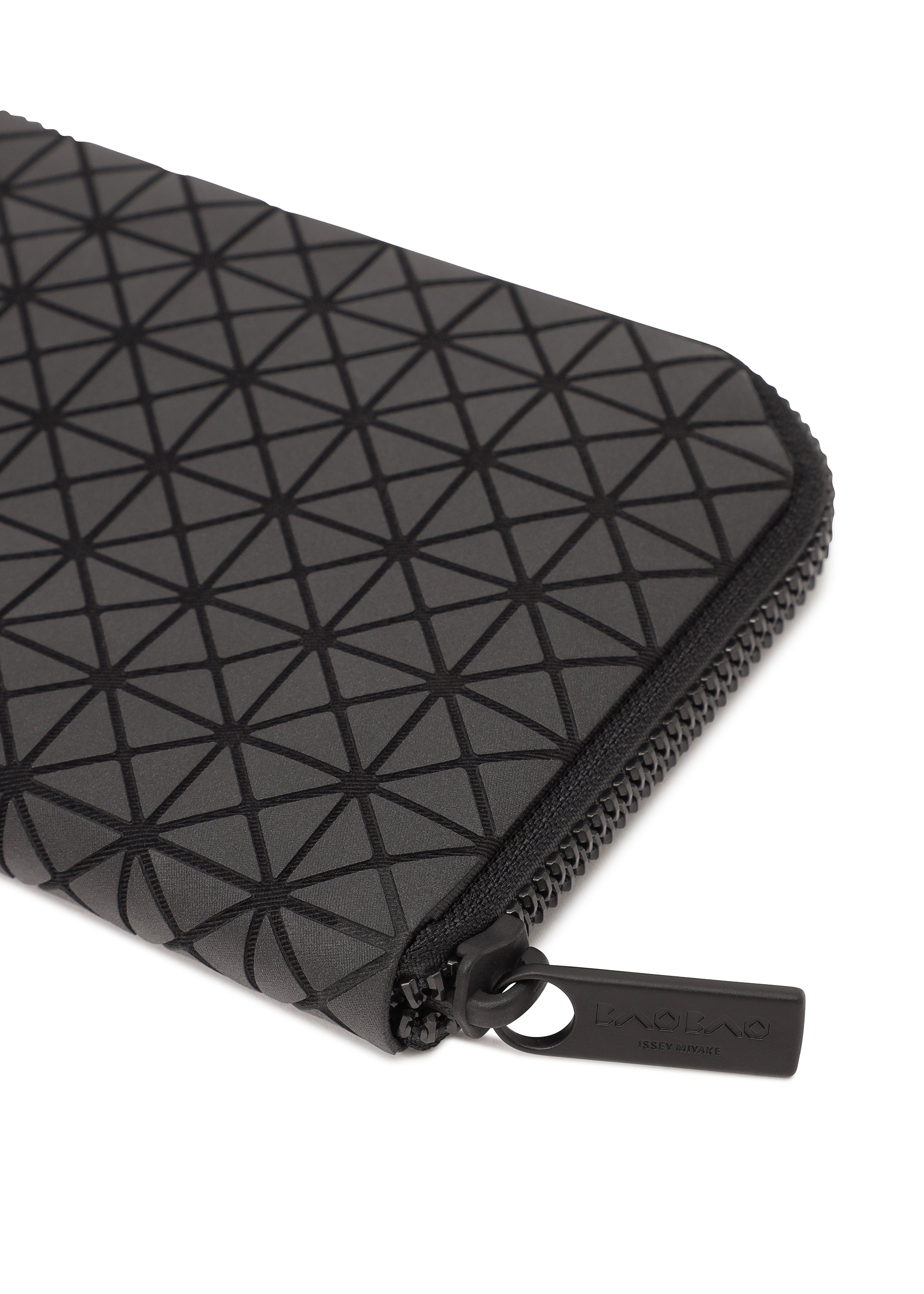 Zoomed view A close-up of the BOUND black zippered pouch by BAO BAO ISSEY MIYAKE, showcasing a geometric triangle pattern, card slots, and a black zipper pull tab embossed with the brand name.