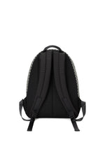 A black DAYPACK AUTOBAHN by BAO BAO ISSEY MIYAKE is shown from the back with padded shoulder straps, a top handle, mesh back panel, patterned side trim, and adjustable straps displayed on a plain white background.