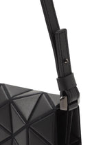 Close-up of the TONNEAU MATTE shoulder bag by BAO BAO ISSEY MIYAKE, showcasing its black geometric triangular-patterned surface, textured strap, and metal buckle detail.
