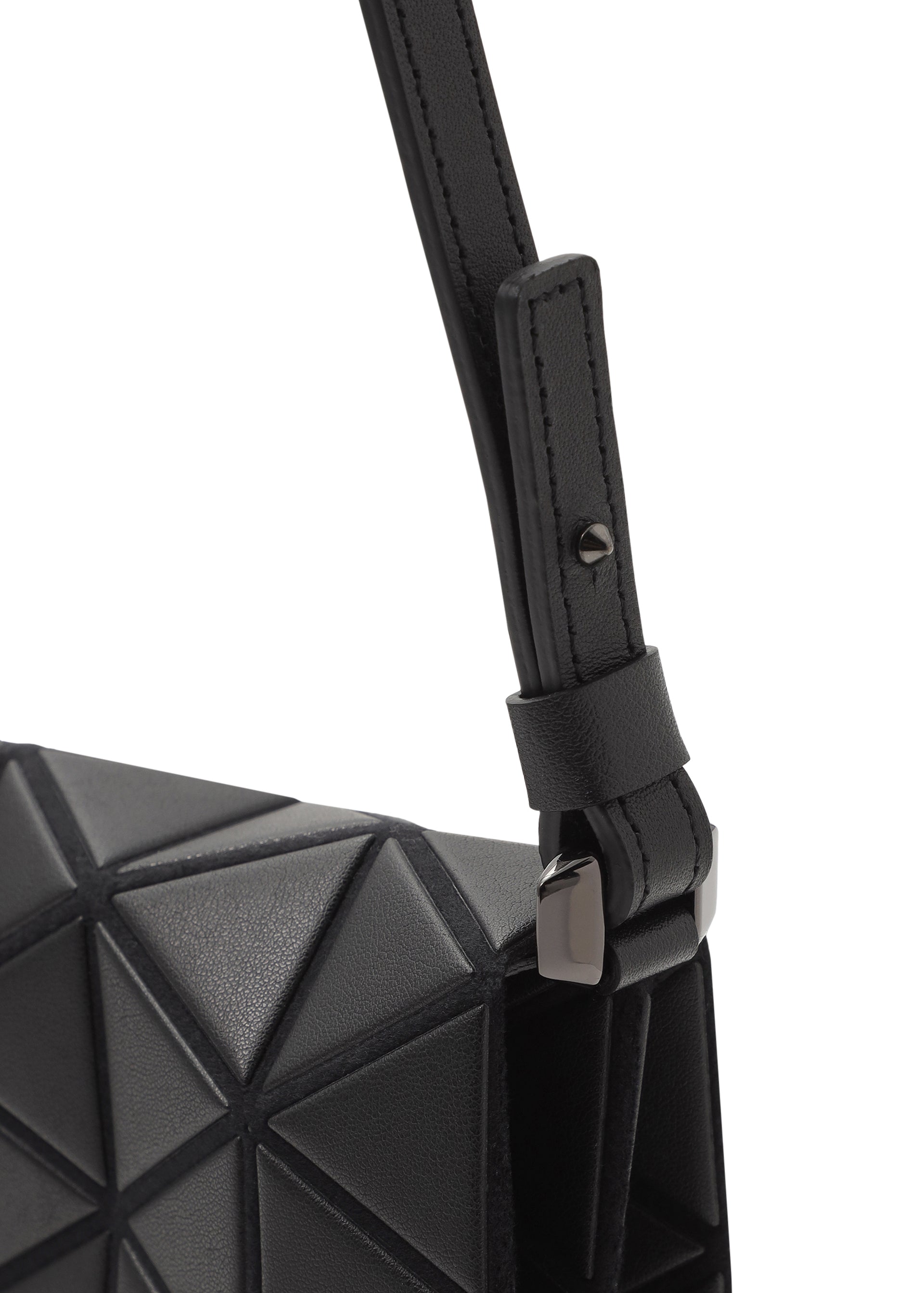 Zoomed view Close-up of the TONNEAU MATTE shoulder bag by BAO BAO ISSEY MIYAKE, showcasing its black geometric triangular-patterned surface, textured strap, and metal buckle detail.