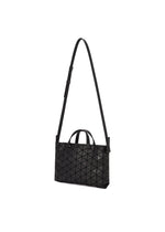 BAO BAO ISSEY MIYAKE’s TONNEAU MATTE is a black, barrel-shaped mini handbag with a geometric pattern, crafted from leather-like matte material. It features an adjustable long strap and two small handles, and is photographed against a white background.