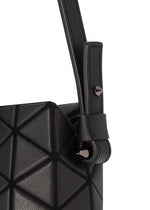 Close-up of the TONNEAU MATTE mini handbag by BAO BAO ISSEY MIYAKE, featuring a black, leather-like matte finish, geometric barrel-shaped silhouette with textured triangular patterns, a strap, and metallic stud accents.