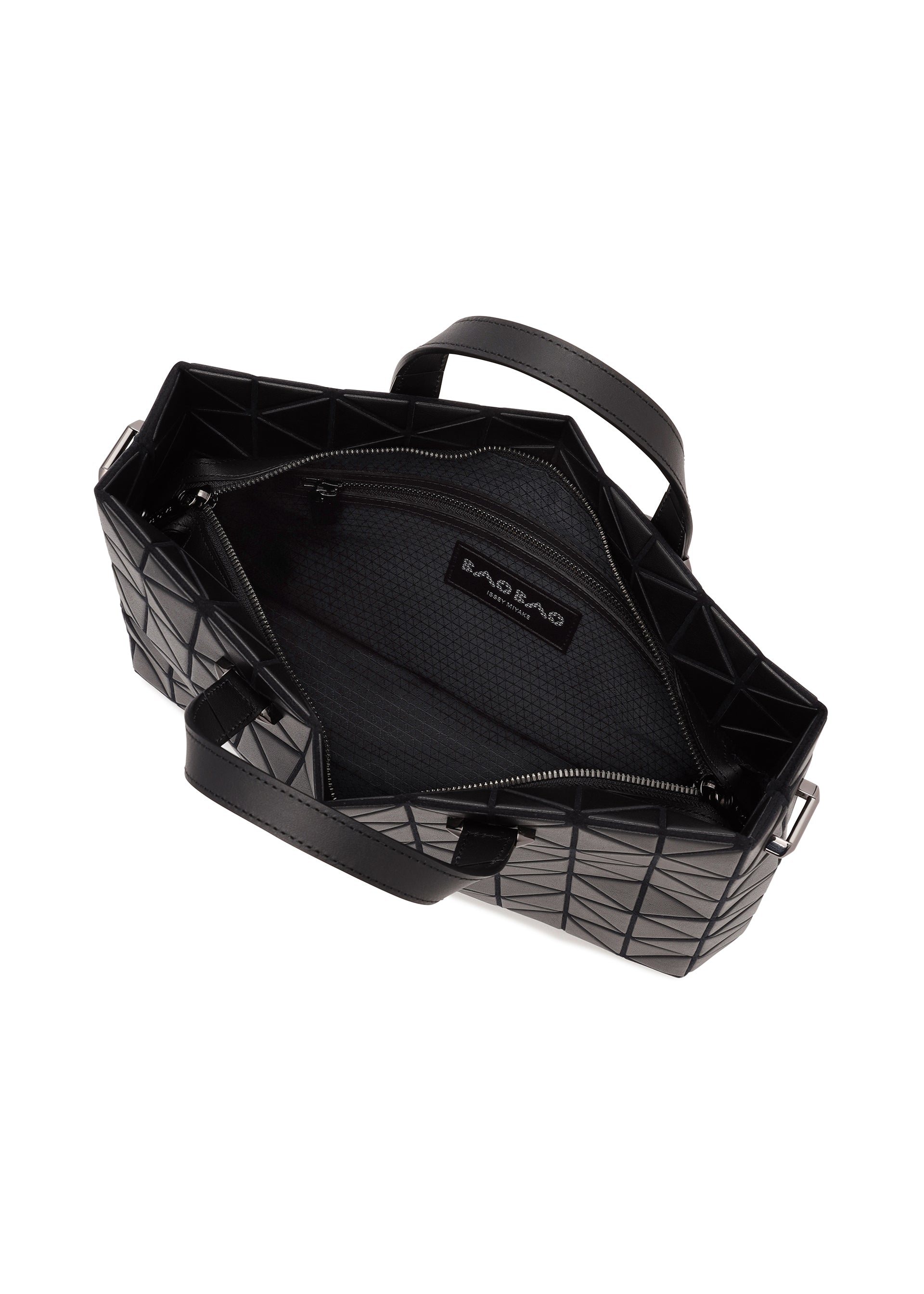 Zoomed view Open black TONNEAU MATTE geometric tote bag by BAO BAO ISSEY MIYAKE, viewed from above, designed to fit A4 size handbag essentials and revealing its spacious interior with fabric lining, zippered pocket, and an inner BAO BAO label. Two black handles are visible on either side of the bag.