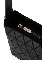 Close-up of the BAO BAO ISSEY MIYAKE CRYSTAL MATTE shoulder bag in black with a geometric pattern, leather straps, and a partially open zipper showing a metal pull engraved with BACBAC. The bag boasts a modern, structured matte design.