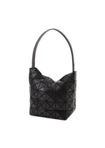 The VALLEY by BAO BAO ISSEY MIYAKE is a black geometric gusseted handbag with a wide strap and textured triangular pattern, designed to stand upright, shown against a white background.