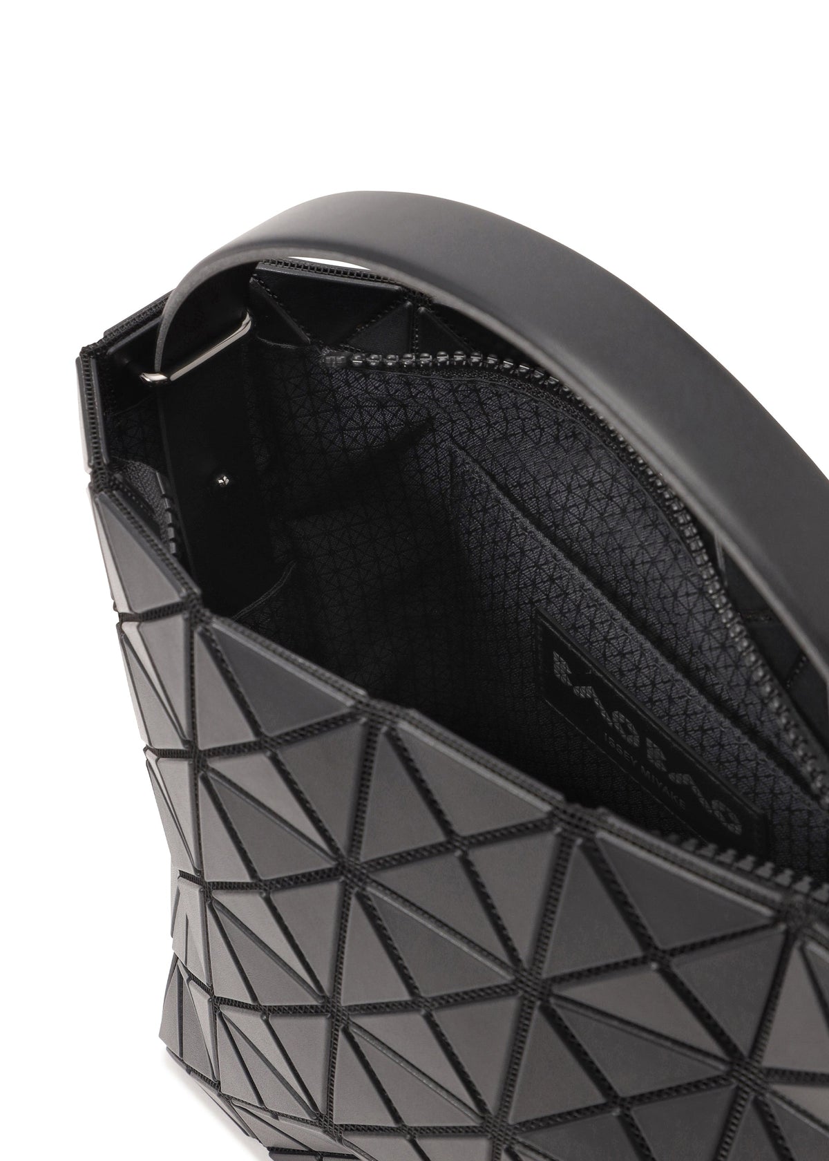 Zoomed view Open VALLEY by BAO BAO ISSEY MIYAKE shows its black geometric-patterned exterior, adjustable handle, interior fabric lining, zipper closure, and brand label inside.