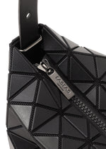 Close-up of a black geometric-patterned gusseted handbag with a metallic zipper partially open, showing the engraved brand name BAO BAO ISSEY MIYAKE on the VALLEY zipper pull.