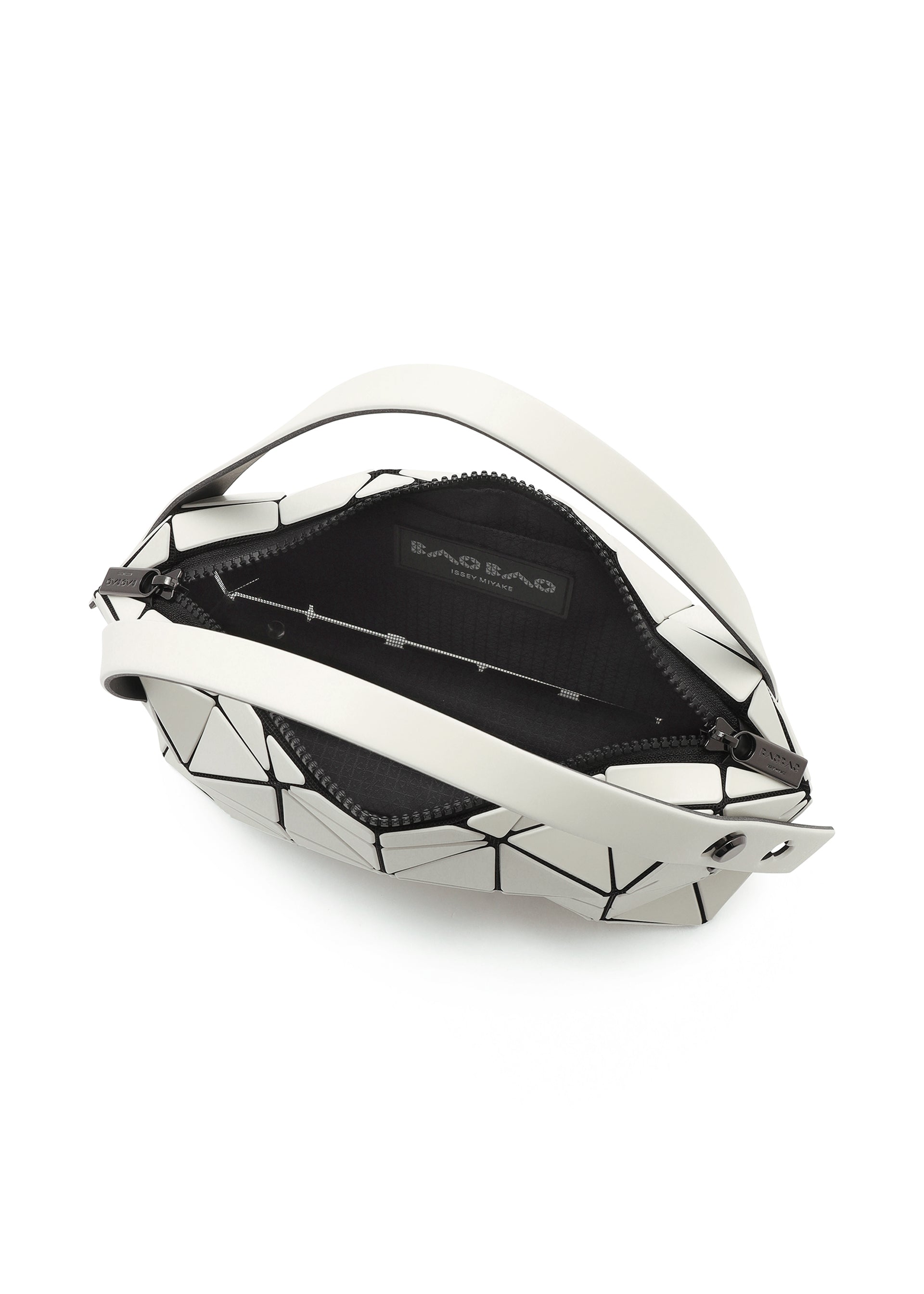 Zoomed view The BOSTON by BAO BAO ISSEY MIYAKE is a mini bag with a geometric black and white triangular pattern, crafted from matte leather-like material. It has a zippered opening, black interior, and features the brand label inside.