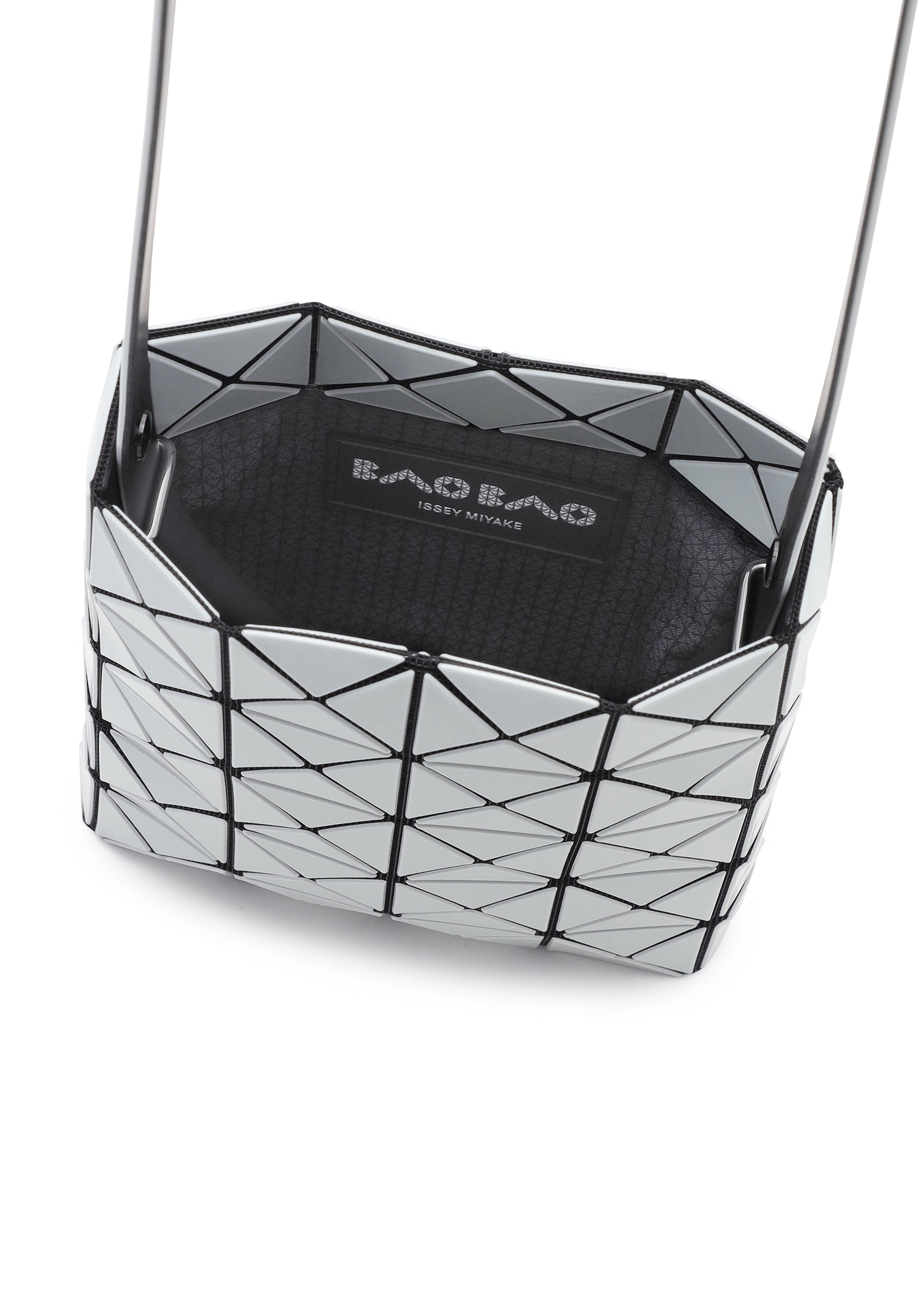 Zoomed view A close-up of a silver geometric-patterned BAO BAO ISSEY MIYAKE PRISM GLOSS shoulder bag, crafted from an enamel-like material with black accents and a visible brand label inside.