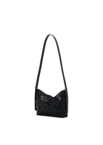 The MUSETTE by BAO BAO ISSEY MIYAKE is a black mini bag featuring a geometric, triangular pattern on its leather-like surface, designed with a long strap and photographed against a white background.