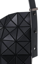 Close-up of the MUSETTE cross-body bag by BAO BAO ISSEY MIYAKE, showcasing its black geometric triangular pattern crafted from a leather-like material, with a strap embellished with metal studs and a rectangular buckle.