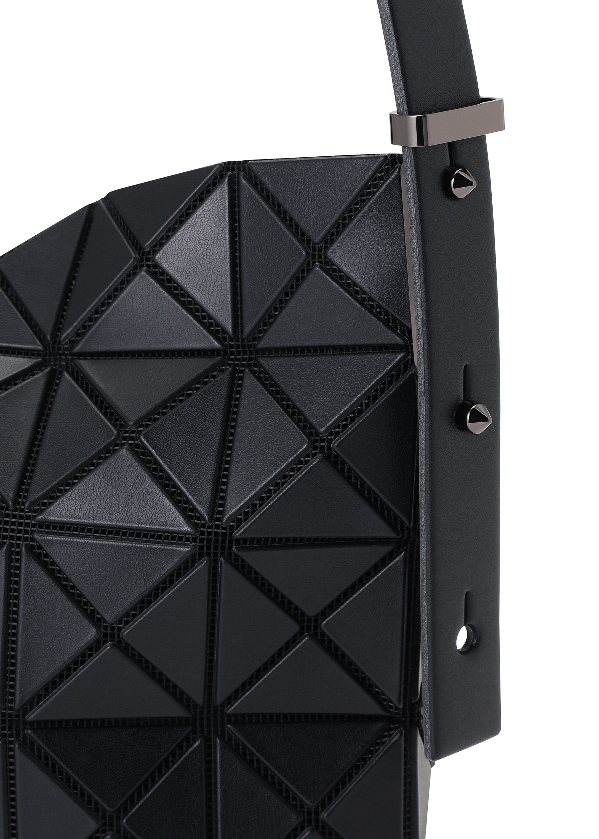 Zoomed view Close-up of the MUSETTE cross-body bag by BAO BAO ISSEY MIYAKE, showcasing its black geometric triangular pattern crafted from a leather-like material, with a strap embellished with metal studs and a rectangular buckle.
