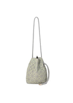 The WRING CLAY by BAO BAO ISSEY MIYAKE is displayed against a white background, featuring a light gray geometric pattern and a long, slender strap with a drawstring closure. This stylish shoulder bag boasts a nubuck-like texture, bringing a modern flair to the classic drawstring bag design. - YELLOW BEIGE （no.48）
