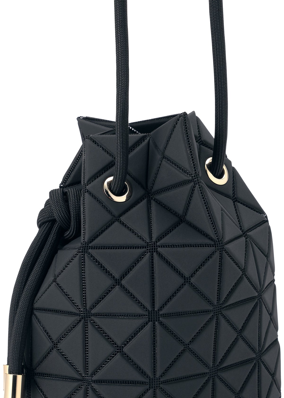 A close-up of the WRING CLAY by BAO BAO ISSEY MIYAKE, a black bucket bag featuring geometric, raised triangular patterns on its nubuck-like surface. Gold grommets and black rope handles accent this edgy drawstring-inspired shoulder bag with a modern design. view 6 of 9