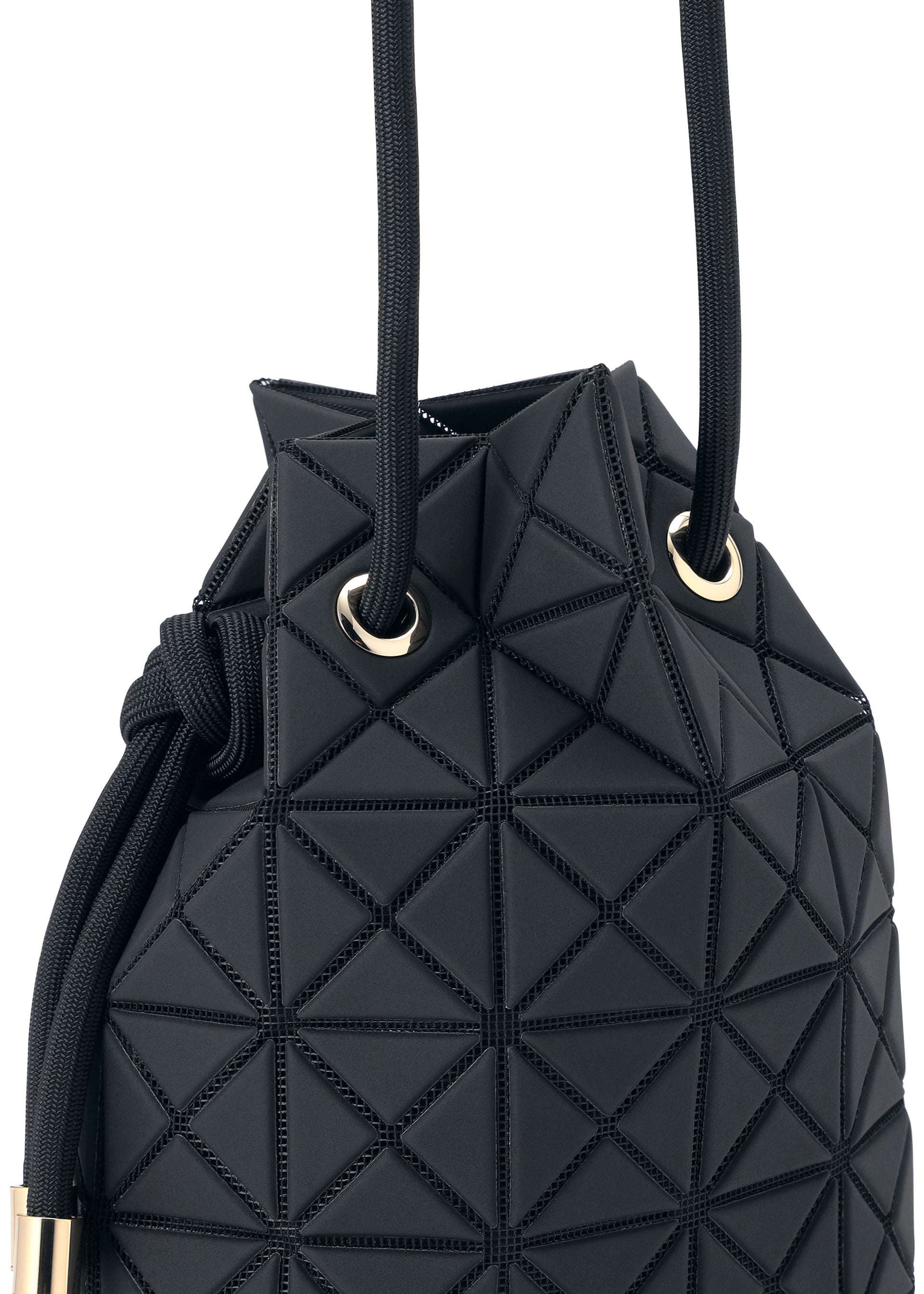 Zoomed view A close-up of the WRING CLAY by BAO BAO ISSEY MIYAKE, a black bucket bag featuring geometric, raised triangular patterns on its nubuck-like surface. Gold grommets and black rope handles accent this edgy drawstring-inspired shoulder bag with a modern design.