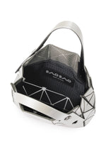 Open CARAT silver geometric handbag with black interior, showcasing the BAO BAO ISSEY MIYAKE logo label inside. Crafted from striking metallic material, this bag features a modern, angular design with a single wide handle and includes an inner pocket for added convenience.