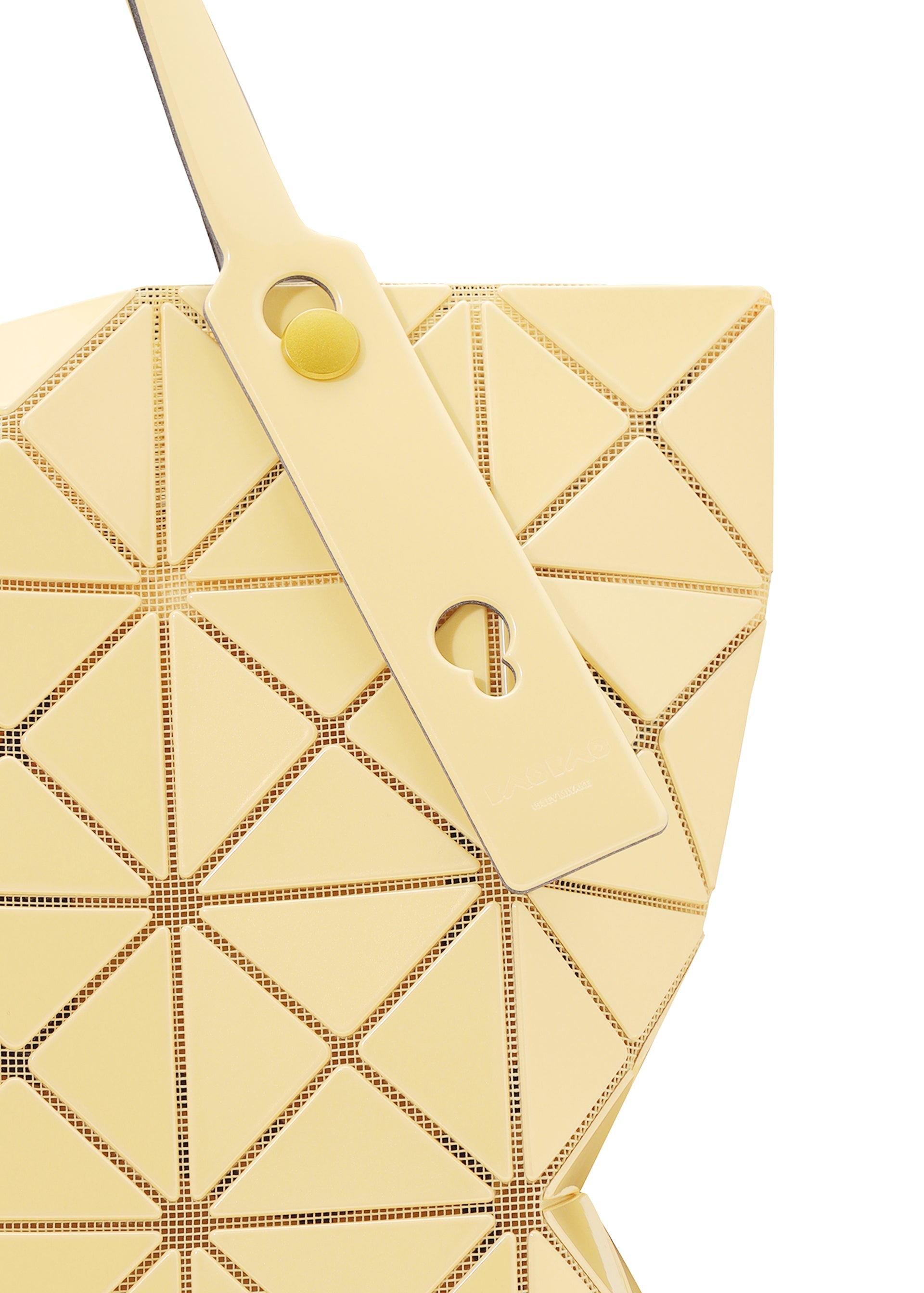 Zoomed view Close-up of the BAO BAO ISSEY MIYAKE LUCENT ONE-TONE tote, showcasing pale yellow glossy enamel geometric panels, perforated edges, a matching strap, and a round yellow button accent.
