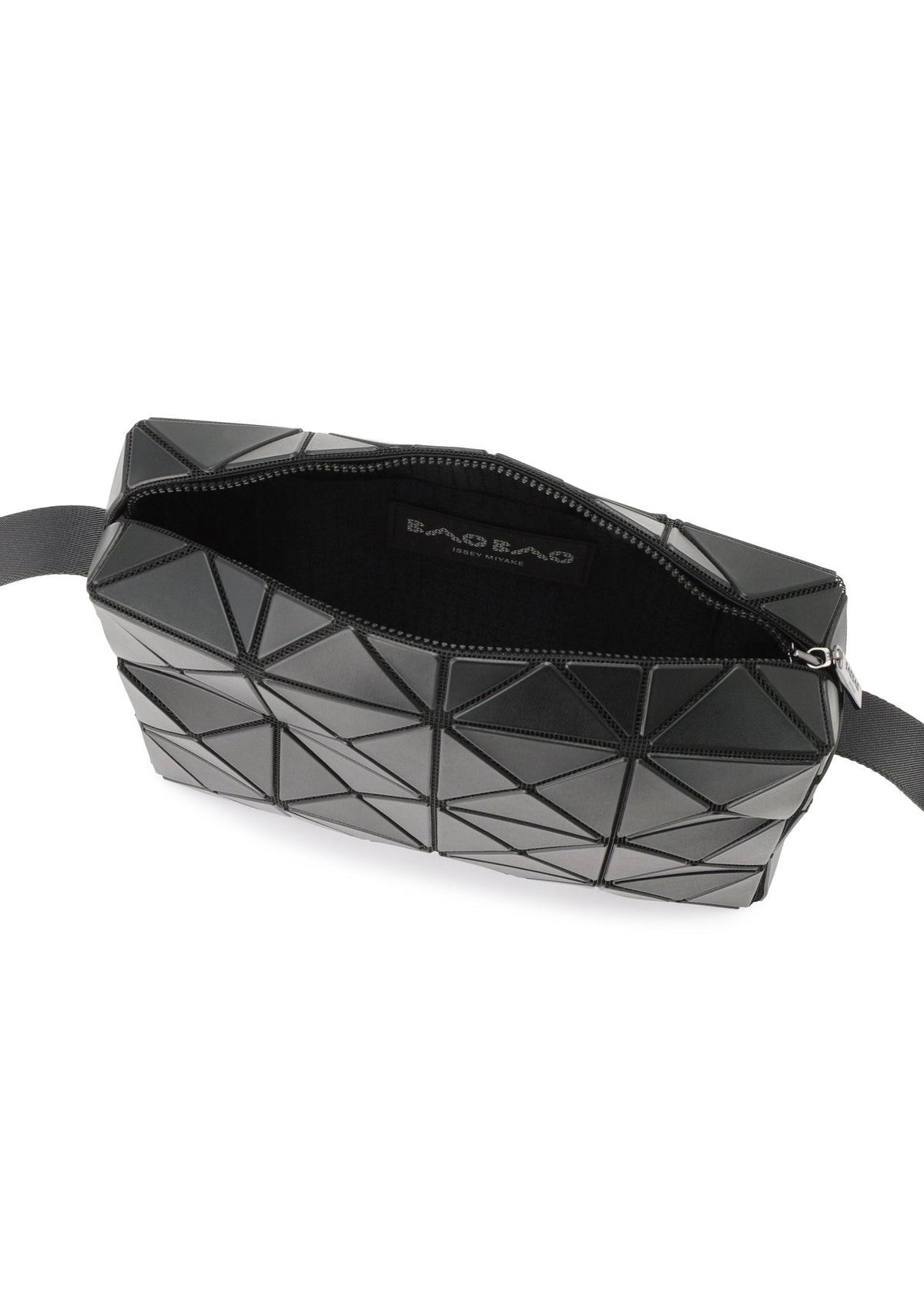 A black crossbody bag from BAO BAO ISSEY MIYAKE, the CUBOID features a geometric pattern with triangular panels and a cuboid silhouette that emphasizes its minimalist design. It is partially unzipped to reveal a black interior and a fabric label inside, with a black strap attached at both ends. view 6 of 8