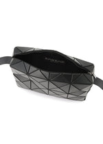A black crossbody bag from BAO BAO ISSEY MIYAKE, the CUBOID features a geometric pattern with triangular panels and a cuboid silhouette that emphasizes its minimalist design. It is partially unzipped to reveal a black interior and a fabric label inside, with a black strap attached at both ends.
