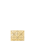 The CARD WALLET by BAO BAO ISSEY MIYAKE is a small, gold rectangular clutch with a geometric pyramid pattern and metallic studs, ideal for use as a chic card case or mini wallet, shown against a plain white background. - SUNLIGHT YELLOW （no.54）