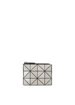 Introducing the CASSETTE by BAO BAO ISSEY MIYAKE: a compact rectangular clutch featuring a striking geometric pattern of silver triangles outlined in black, set against a white background. Finished with a top zipper closure, this stylish accessory is perfect as a zipper case or coin pouch. - PEARL GRAY （no.05）