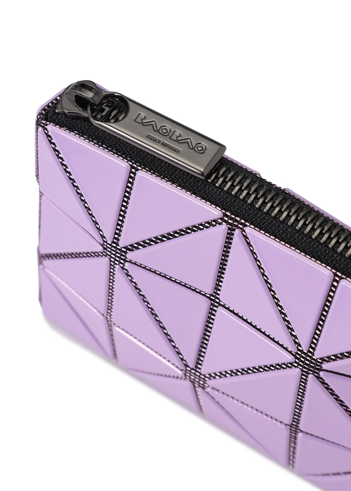 Here is your rewritten sentence using the provided product data: Close-up of a lavender geometric CASSETTE pouch from BAO BAO ISSEY MIYAKE, featuring triangular panels with black seams and a black zipper. The zipper pull is engraved with the brand name. This stylish zipper case combines modern design and function, making it perfect as a card holder or coin pouch. view 7 of 8