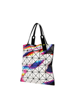 The WARP tote bag by BAO BAO ISSEY MIYAKE features black handles and a lively geometric pattern of pink, blue, yellow, and purple triangles on white—perfect for carrying your A4 laptop in style.
