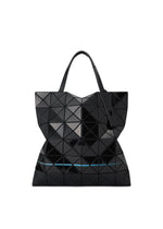 The WARP tote by BAO BAO ISSEY MIYAKE is a black geometric bag with glossy triangular panels, two handles, a modern sculptural design, and a subtle blue accent line near the bottom.