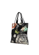 Introducing the COSMIC tote bag by BAO BAO ISSEY MIYAKE—a spacious geometric black tote featuring glossy enamel triangular panels adorned with a vibrant abstract pattern, two sleek black straps, and finished with silver rivet accents. Perfectly sized to carry your A4 documents.
