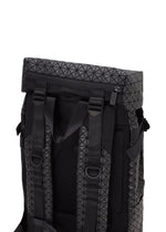 A close-up of the back of a BAO BAO ISSEY MIYAKE HIKER backpack highlights padded shoulder straps, adjustable buckles, and a top zipper with a black geometric pattern and laptop pocket, set against a white background.